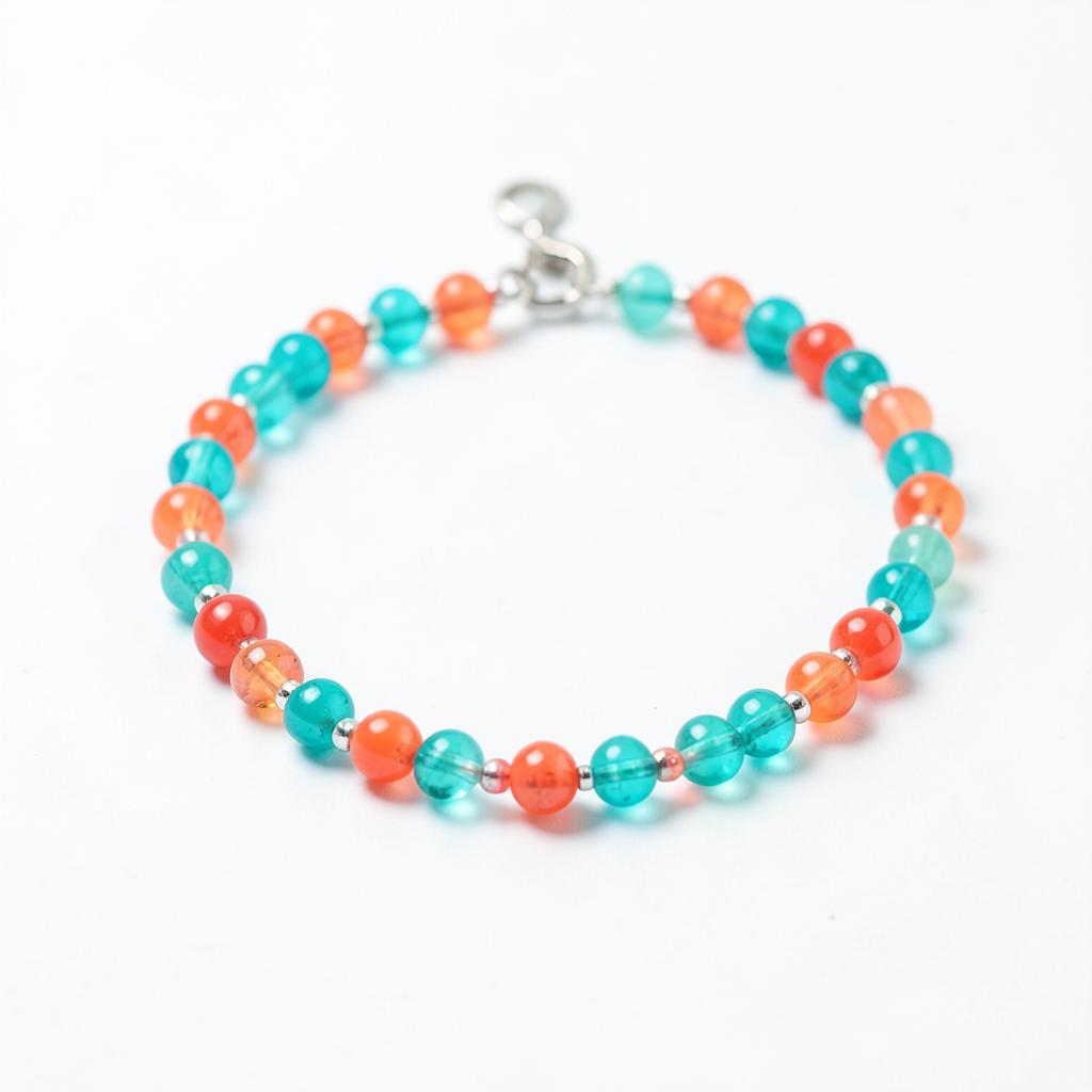 Colorful turquoise and coral beaded anklet on a white background
